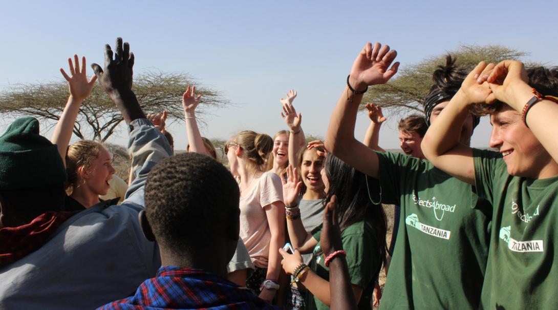 A local community in Tanzania meets up with Projects Abroad volunteers. Projects Abroad volunteers in Tanzania are dancing with the local community they are working with.